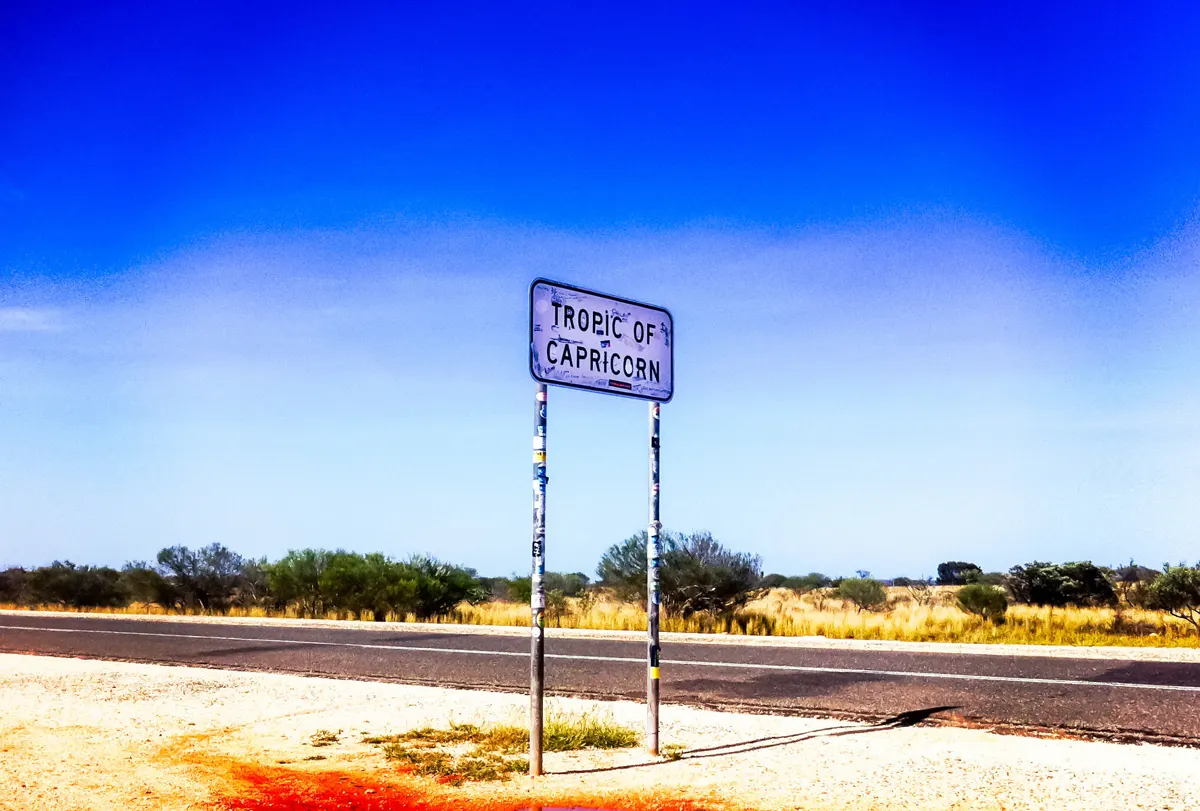 A Tropic of Capricorn sign beside an outback highway